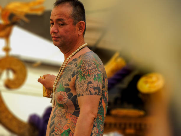 Traditional Japanese yakuza tattoo showing full-body irezumi with cherry blossoms and traditional motifs